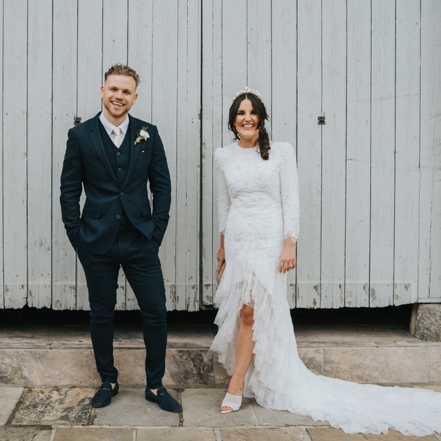 Alt text: Bride in lace tea-length dress at civil ceremony, timeless romantic bridal look, soft lace detail