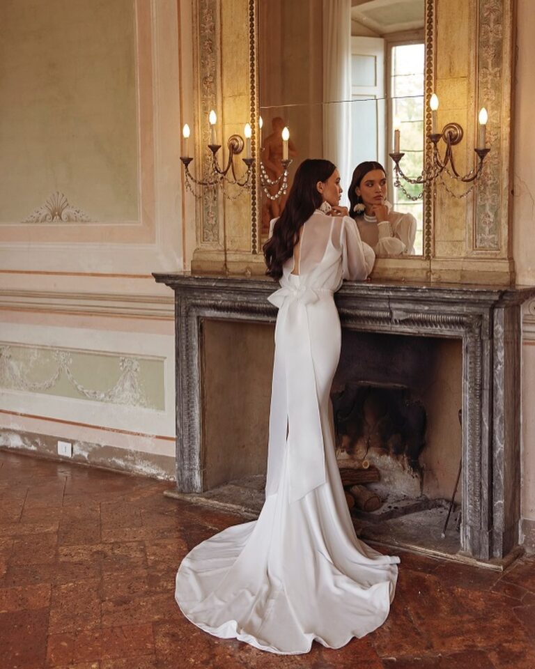 Alt text: Bride in minimalist ivory sheath dress, clean silhouette civil ceremony look, sophisticated simple bridal style