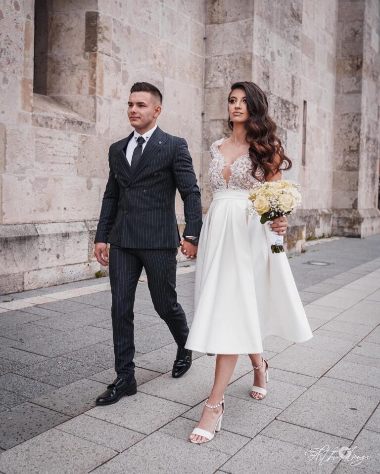 Alt text: Bride in white pleated skirt dress at civil ceremony, graceful flowing bridal look, midi length wedding dress