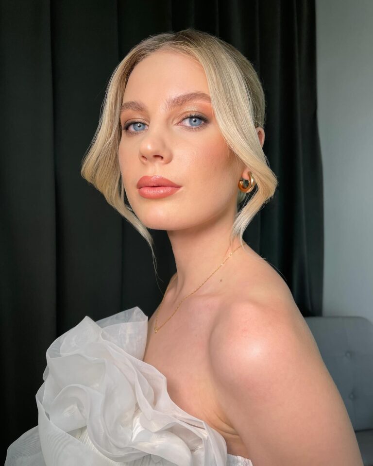 Bride with champagne shimmer eyeshadow on lids, soft light-catching eye look, ethereal bridal makeup