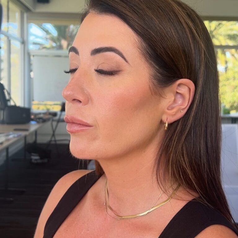 Alt text: Bride with pearl inner corner eye highlight, brightened open eyes, soft glowy bridal makeup, close-up portrait natural light