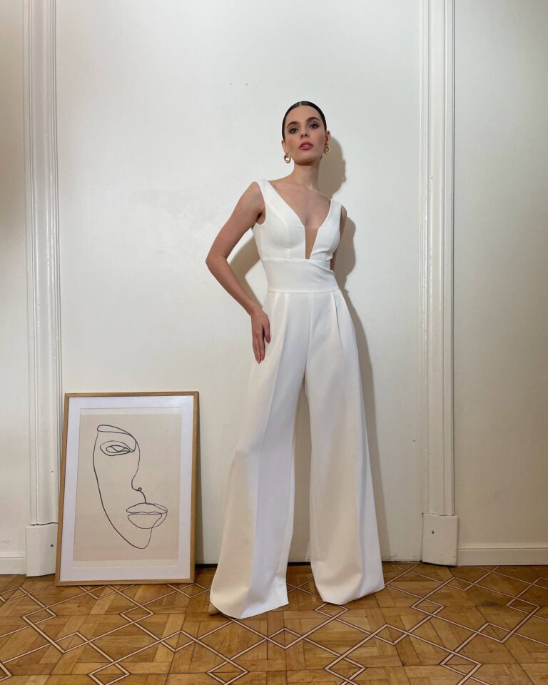 Alt text: Bride in a white bridal jumpsuit at courthouse wedding, modern and chic non-dress option