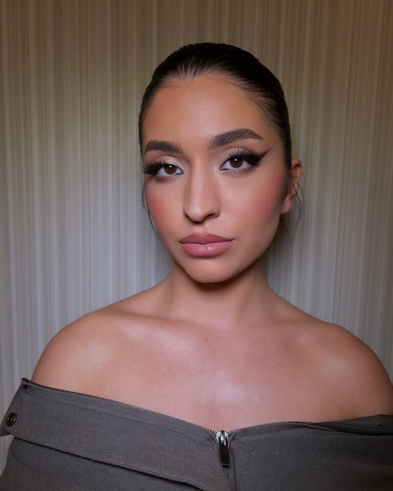 Bride with dewy glowing skin and peach blush, warm radiant bridal makeup, outdoor natural light