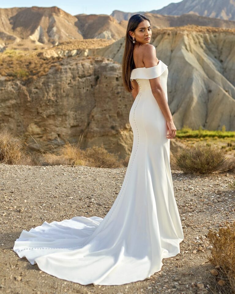 Bride in minimalist ivory sheath dress, clean lines, city rooftop elopement look