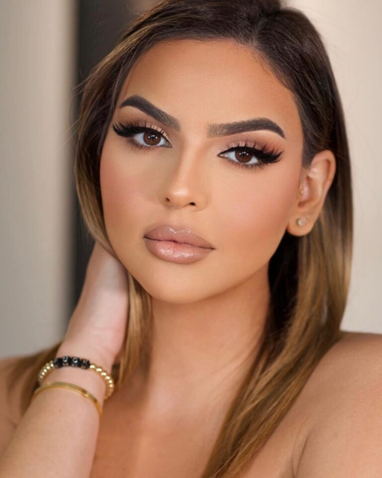 Alt text: Bride with softly groomed natural brows brushed with clear gel, polished minimal bridal look, close-up portrait