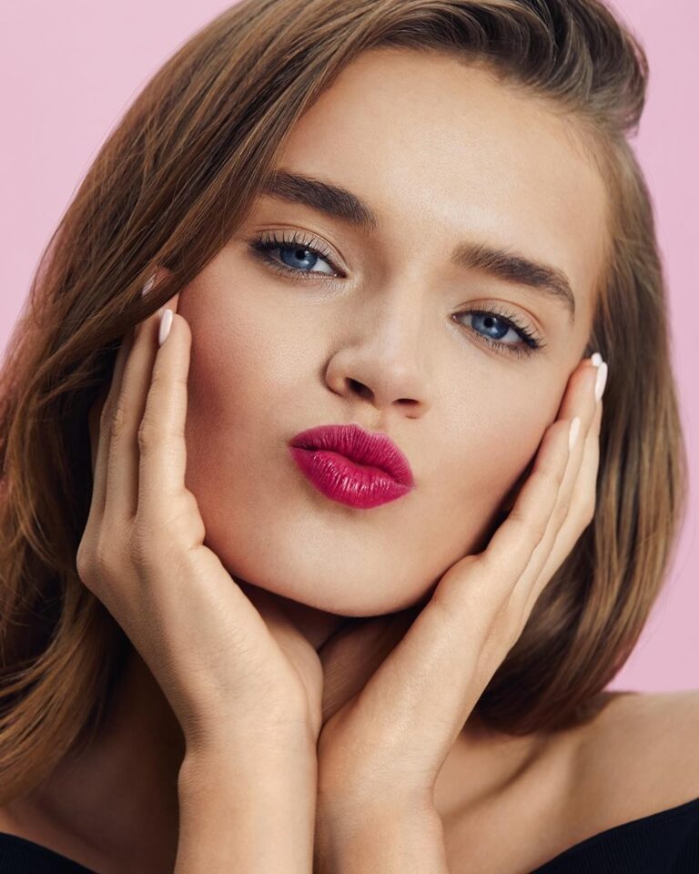 Alt text: Bride with barely-there lip tint, sheer natural lip color close to skin tone, soft bridal lip look