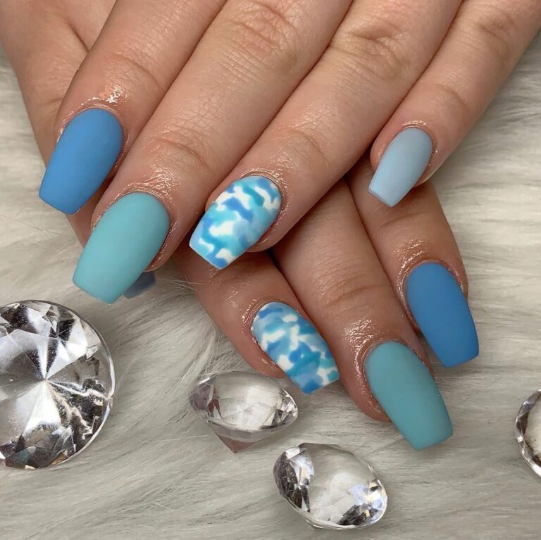 Alt text: Matte dusty blue nails on a bride's hand, velvety soft finish, modern bridal manicure flat lay